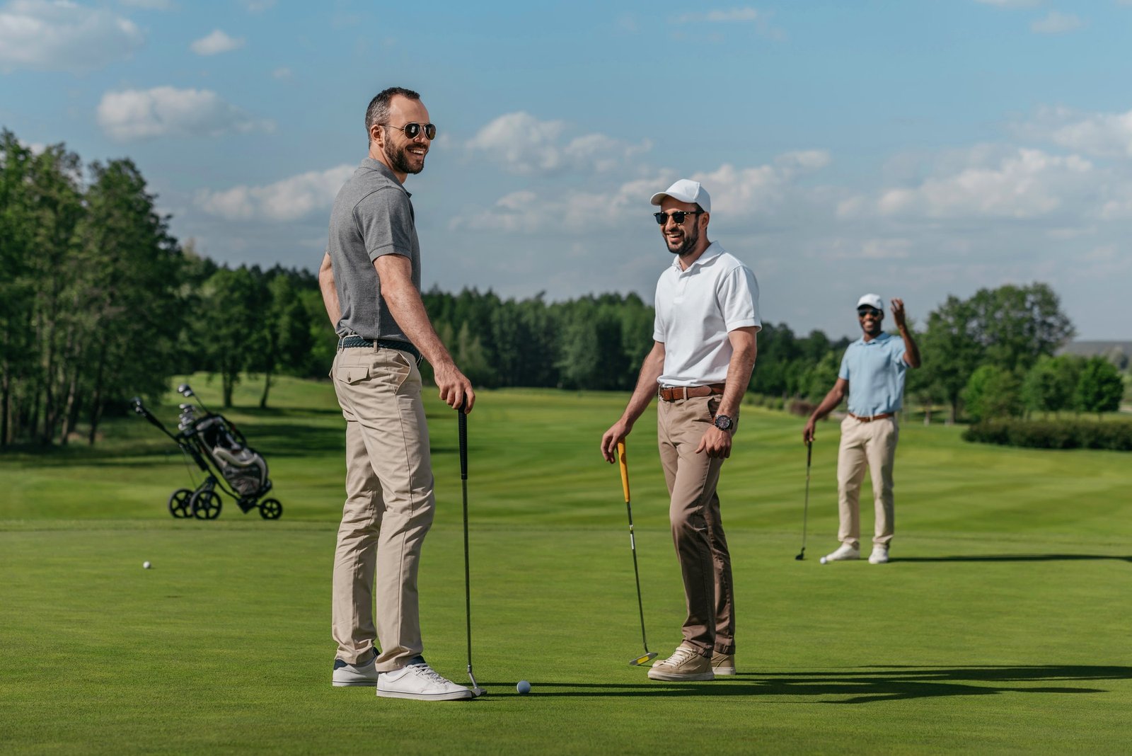 smiling-friends-talking-while-playing-golf-together-on-green-at-daytime.jpg smiling-friends-talking-while-playing-golf-together-on-green-at-daytime.jpg